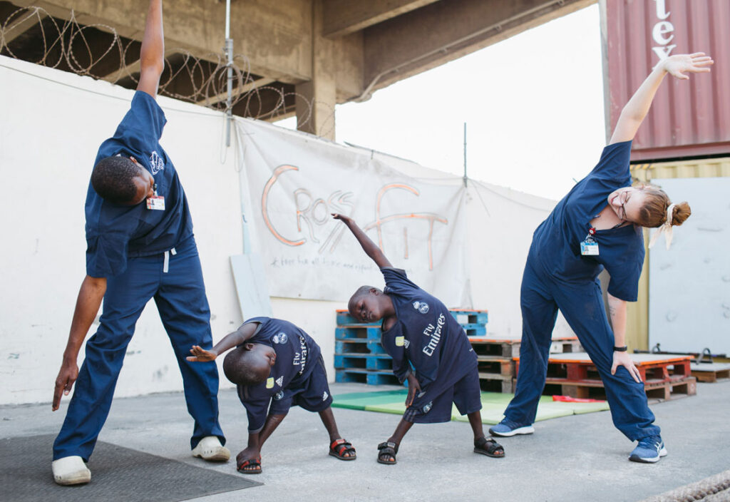 Ousseynou and Assane at physiotherapy - stretching