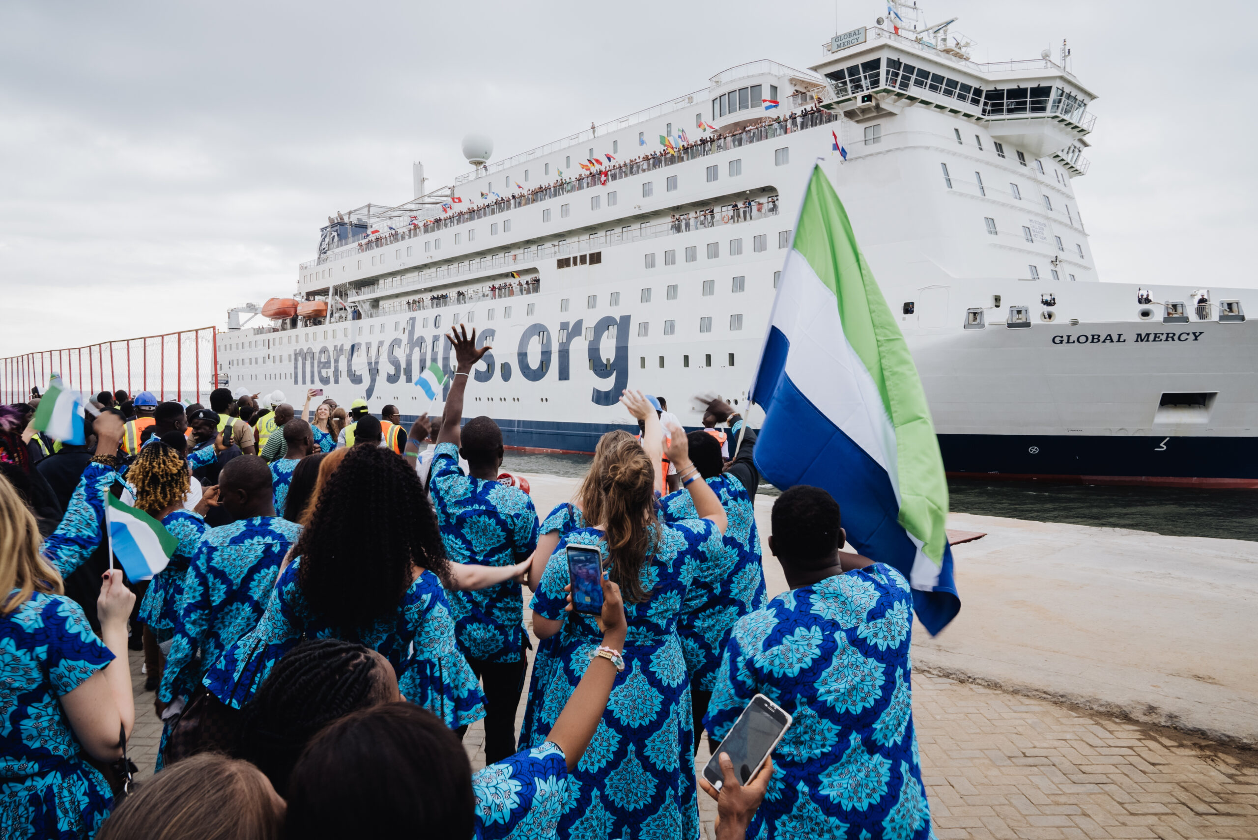 Members of the Country Engagement Team celebrating on the dock of Queen Elizabeth II Quay in Freetown as the Global Mercy arrives.