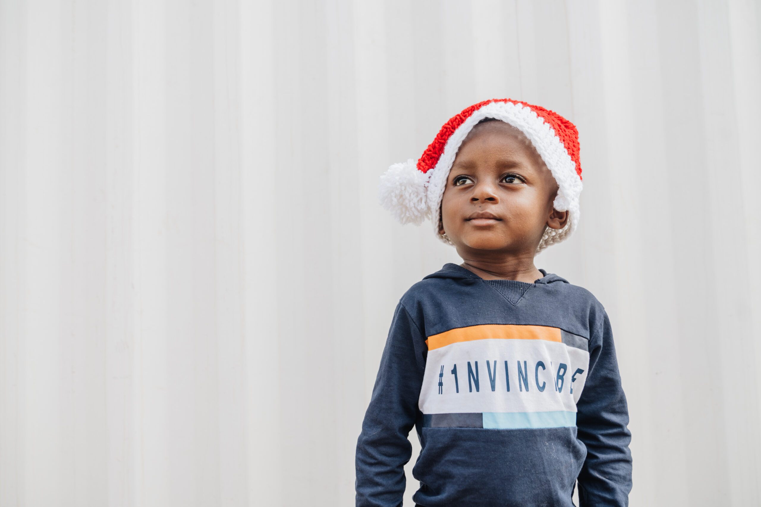 Emmanuel, maxillofacial patient, wearing a christmas hat.